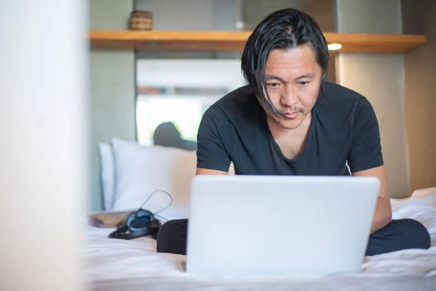 Man on his laptop at home checking his loan options