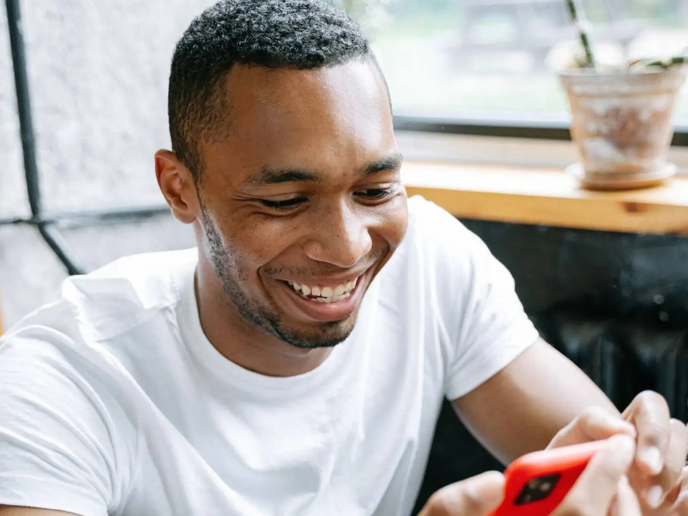 Smiling man checking a payday loan offer on his phone