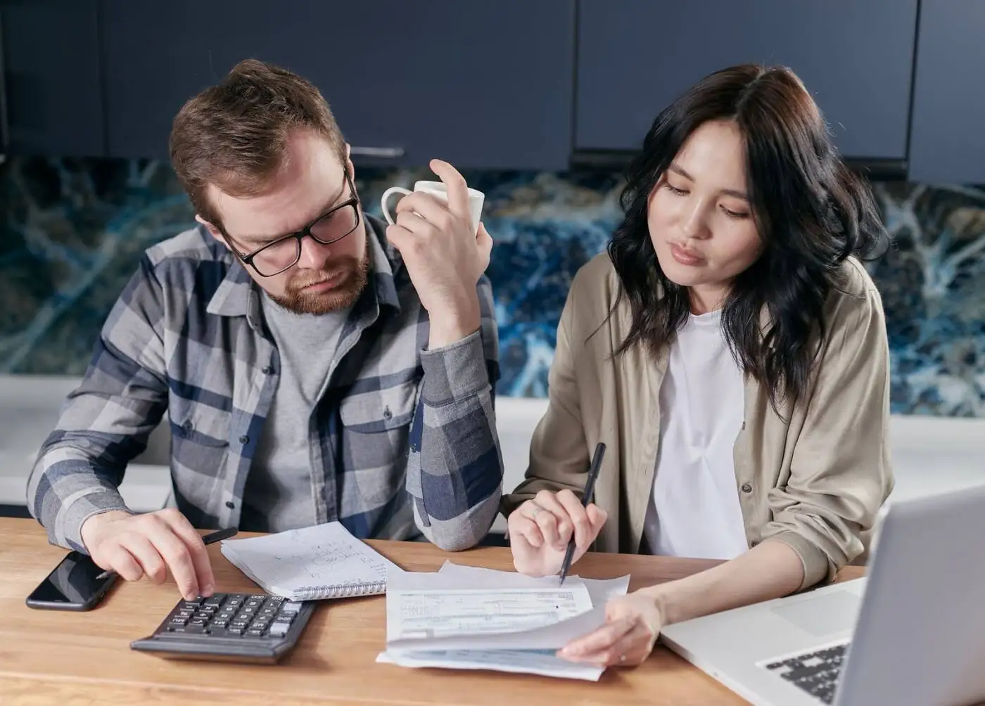 Couple going through their bills and budget at the kitchen table